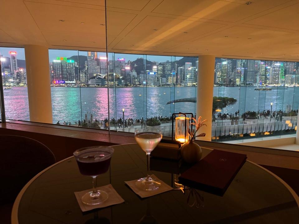 Two drinks in front of view of Hong Kong at night 