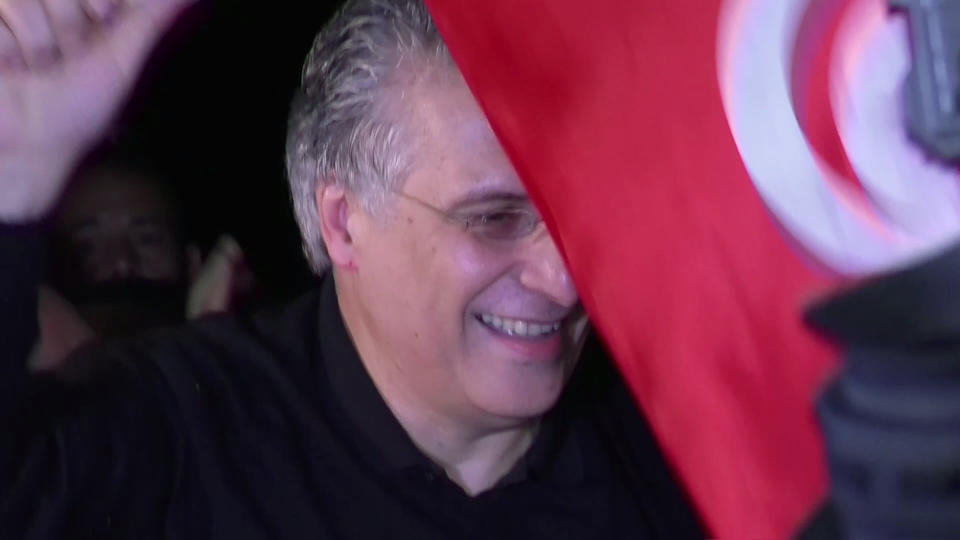 In this image from TV, Tunisian presidential candidate and media mogul Nabil Karoui, is greeted by jubilant crowds after he was released from prison in Mannouba, Tunisia, Wednesday Oct. 9, 2019, just four days before the upcoming presidential runoff election. Karoui has been jailed since August under investigation for alleged money laundering and tax fraud that he asserts as a politically motivated smear campaign. (AP Photo)