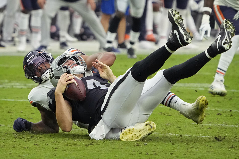 Chicago Bears linebacker Trevis Gipson (99) sacks Las Vegas Raiders quarterback Derek Carr (4) during the second half of an NFL football game, Sunday, Oct. 10, 2021, in Las Vegas. (AP Photo/Rick Scuteri)