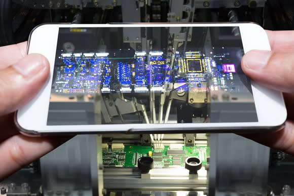 A smartphone scanning a circuit board.