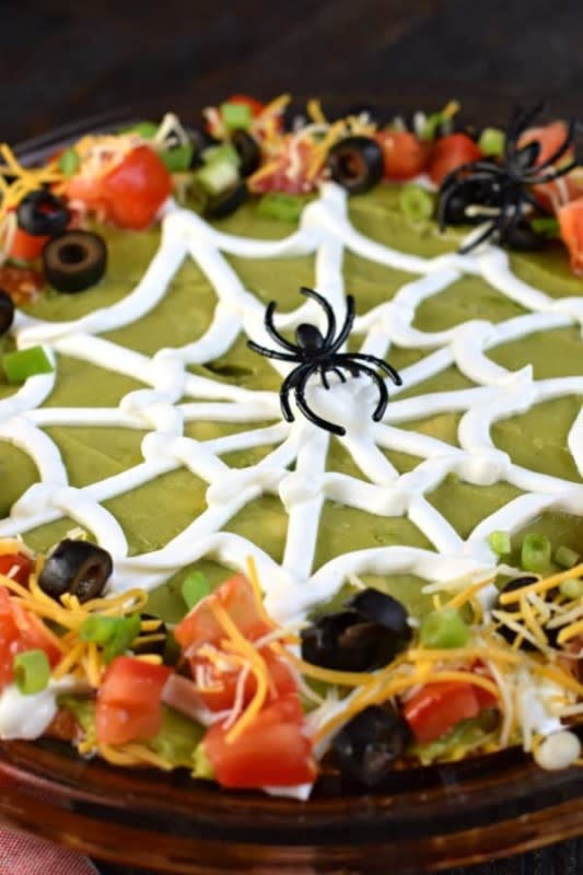 <p>Shugary Sweets</p><p>This spook-tacular 7 layer dip is the perfect holiday appetizer. Add the spooky spider web for the holiday, or keep it smooth for year round enjoyment!</p><p><strong>Get the recipe: </strong><a href="https://www.shugarysweets.com/7-layer-taco-dip/" rel="nofollow noopener" target="_blank" data-ylk="slk:Halloween 7 Layer Dip;elm:context_link;itc:0;sec:content-canvas" class="link "><strong>Halloween 7 Layer Dip</strong></a></p>