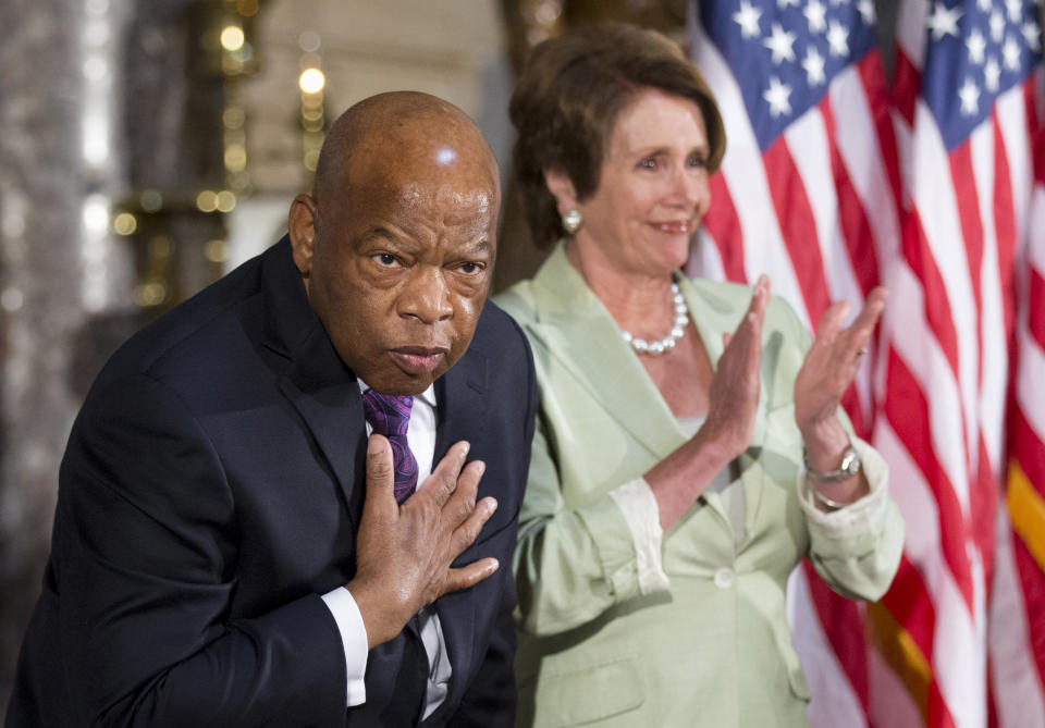 Rep. John Lewis, D-Ga., left, with House Minority Leader Nancy Pelosi of Calif., acknowledges the applause during a ceremony on Capitol Hill in Washington on July 31, 2013, in observance of the 50th anniversary of the March on Washington for Jobs and Freedom.  (Photo: Manuel Balce Ceneta/AP)