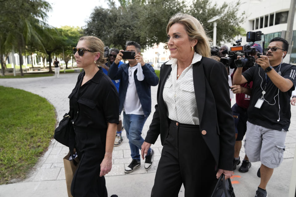 Defense lawyer Jacqueline Arango, center, and Karla Wittkop Rocha, left, wife of Manuel Rocha, are trailed by journalists as they leave the James Lawrence King Federal Justice Building in Miami, Monday, Dec. 4, 2023. Manuel Rocha, 73, a former American diplomat who served as U.S. ambassador to Bolivia, has been charged with serving as a secret agent for Cuba's intelligence services dating back decades, the Justice Department said Monday. (AP Photo/Rebecca Blackwell)
