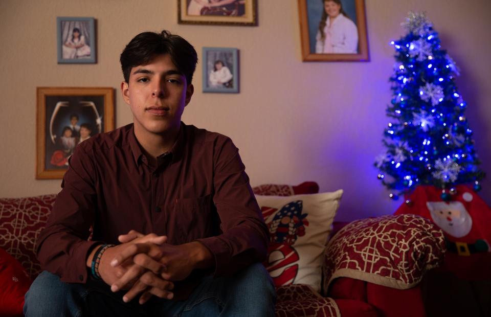 Jonah Sandoval, 19, and his girlfriend Vanessa Tindugan, 18, sit in the living room of his grandparents' house, March 12, 2022, in Corpus Christi, Texas. Sandoval said his grandmother left the family's Christmas decorations up to brighten the home during the trial and decorated the with blue lights to signify justice.