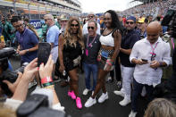 Serena Williams, left, and sister Venus Williams, right, pose for a photo with another race goer, on the starting grid just before the start of the Formula One Miami Grand Prix auto race, at Miami International Autodrome in Miami Gardens, Fla., Sunday, May 7, 2023. (AP Photo/Rebecca Blackwell)