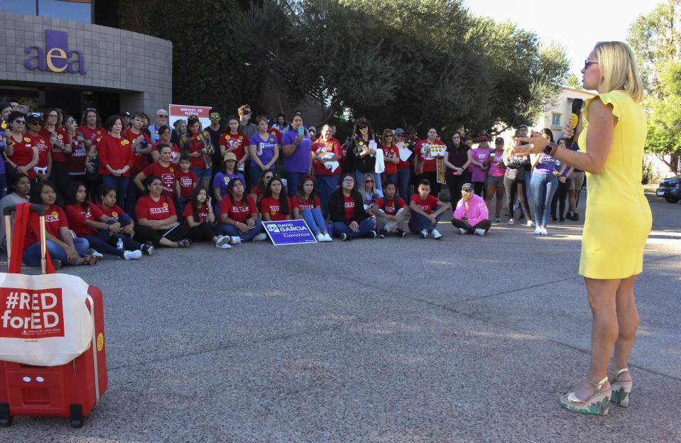 FILE--In this Nov. 3, 2018, file photo, Democratic U.S. Senate candidate Kyrsten Sinema, right, encourages supporters at a get-out-the vote event at the Arizona Education Association headquarters in Phoenix. The congresswomen running for Arizona Senate are in their final campaign swing. Republican Rep. Martha McSally barnstormed across rural Arizona while Sinema dashed around metro Phoenix. The two candidates were trying to turn out every last voter in the neck-and-neck race. AP Photo/Bob Christie, File)