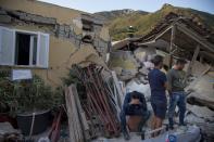 <p>A man sits on a bucket as others look on near a wracked building after 4.0-magnitude richter scale earthquake hit Ischia Island’s Casamicciola Terme of Naples, Italy on Aug. 22, 2017. (Photo: Alessio Paduano/Anadolu Agency/Getty Images) </p>