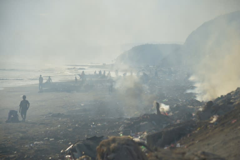 Haitians in Jeremie are having to clear debris on beaches in the wake of Hurricane Matthew without the benefit of protection from toxic fumes