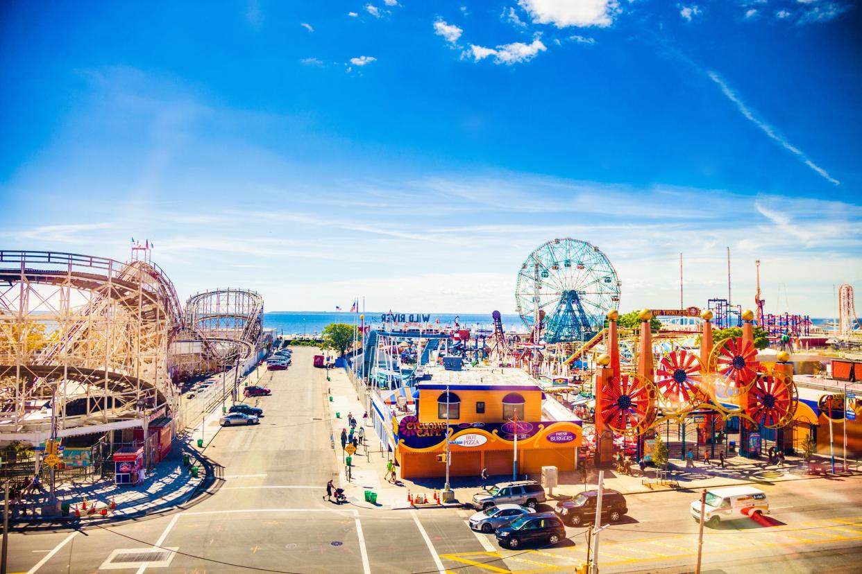 New York, USA -August 29, 2014: Aerial view of Coney Island amusement park, on the left side is visible a section of the famous Cyclone Rollercoaster, on the right side all the rest of the park during an hot summer day.