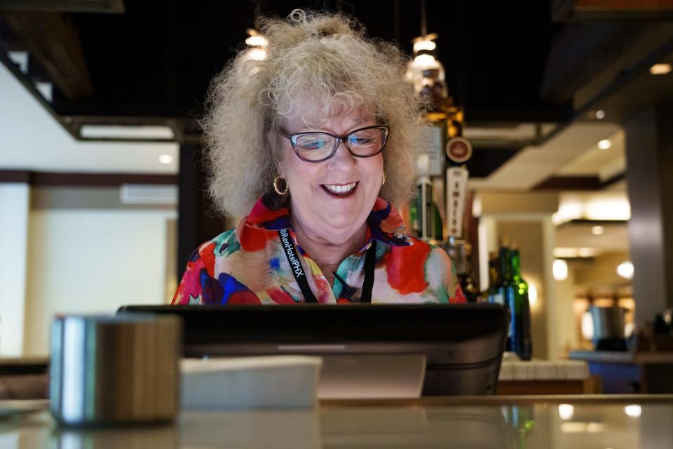 Rhonda Benston-Showman talks to patrons as she puts in an order behind the bar at the Renaissance Phoenix Downtown Hotel on Aug. 18, 2023.