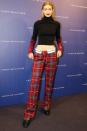 <p>In a Tommy x Gigi striped turtleneck, plaid pants and black creepers at a Tommy x Gigi event in Barcelona.</p>