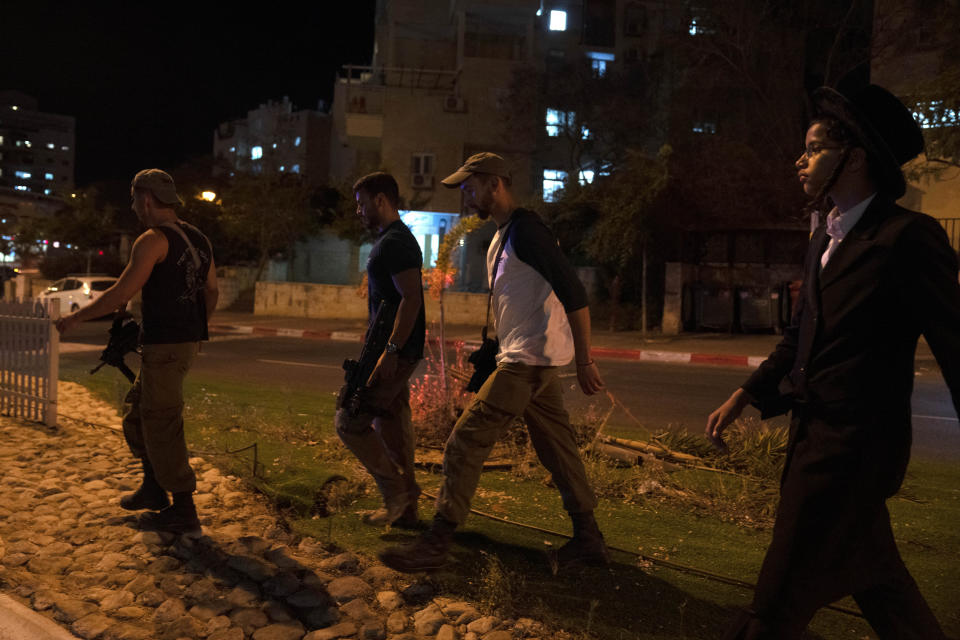 Israeli security forces respond to a stabbing attack in the town of Elad, Israel, Thursday, May 5, 2022. Israeli medics say at least three people were killed in a stabbing attack near Tel Aviv on Thursday night. Israeli police said they suspect it was a militant attack. (AP Photo/Maya Alleruzzo)