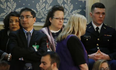 Rowan County Kentucky Clerk Kim Davis (C), who was jailed for five days after refusing to issue marriage licenses to same-sex couples after the U.S. Supreme Court ruled that same sex marriage was legal in June, sits in the House Gallery waiting for the start of U.S. President Barack Obama's State of the Union address to a joint session of Congress in Washington, January 12, 2016. REUTERS/Carlos Barria