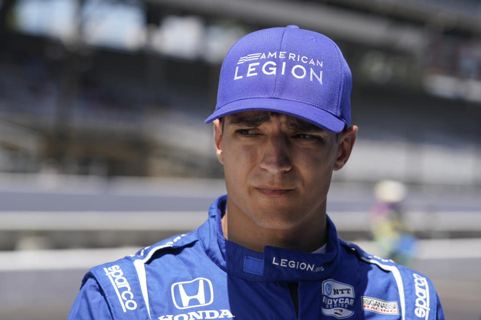 FILE - Alex Palou, of Spain, waits in his pits during qualifications for an IndyCar auto race at Indianapolis Motor Speedway, Friday, July 29, 2022, in Indianapolis. The conversation might not have even lasted 10 seconds. It was more of an exchange, really, but whatever Chip Ganassi said to Alex Palou after Sunday's, Aug. 7, 2022, race in Nashville was their first direct conversation since the reigning IndyCar champion said he was leaving the team. There's three races left in the season, Palou is in the thick of the title hunt and Ganassi is suing him. (AP Photo/Darron Cummings, File)