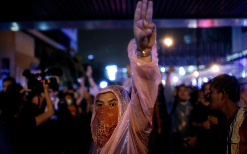 The three-finger salute has become a symbol for the protesters - AFP