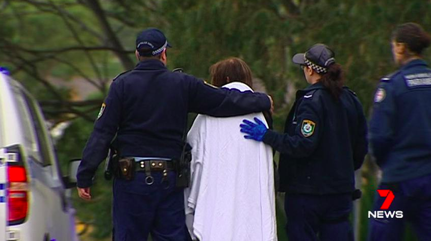 A woman speaks to police after a stabbing in Carlingford. Source: 7 News