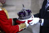 The crown of Britain's Queen Elizabeth II is carried to the official State Opening of Parliament in London, Monday Oct. 14, 2019. (Hannah McKay/Pool via AP)