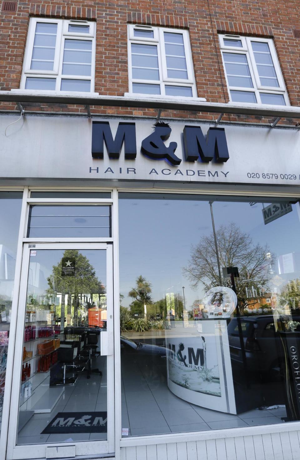 A view of M&M Hair Academy in London, Wednesday, April 16, 2014. Staff at a London hair salon say they had a close shave with North Korean officials after using the country's leader, Kim Jong Un, to promote discount haircuts. M&M Hair Academy says it received a visit by two men from the nearby North Korean embassy after putting up a poster last week featuring a picture of Kim — who sports a distinctive undercut — and the slogan "Bad Hair Day?" (AP Photo/Kirsty Wigglesworth)