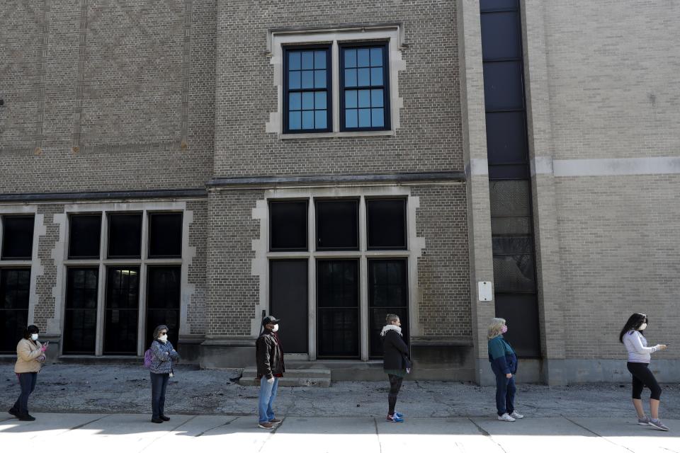 Voters observe social distancing guidelines as they wait in line to cast ballots at Washington High School while ignoring a stay-at-home order over the coronavirus threat to vote in the state's presidential primary election, Tuesday April 7, 2020, in Milwaukee. (AP Photo/Morry Gash)