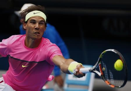 Rafael Nadal of Spain stretches to hit a return to Tomas Berdych of the Czech Republic during their men's singles quarter-final match at the Australian Open 2015 tennis tournament in Melbourne January 27, 2015. REUTERS/Thomas Peter