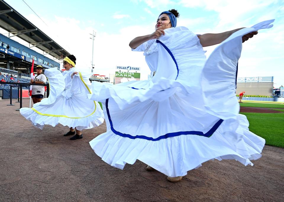 Yaraceli Reyes, 14, right, and Cassandra Santana , 24, both of Worcester, perform for Ritmos Dance Studio during the pregame ceremony.