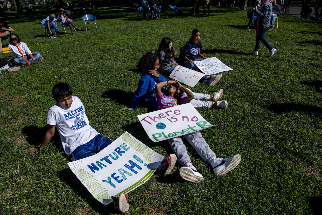 FILE - From left, Raam Melbani, 17, Giselle Barker, 14, Azuri Brown, 15, Charlotte E., 17, and Arya Prasad, 17, listen to speakers for the Global Climate Strike protests in New York on Sept. 23, 2022. The climate change generation is saying officials are talking too much, listening too little and acting even less. And they are fed up. “The question should be like, what should the leaders do? What should governments do? Because this whole time I’ve done activism, I have realized the youth have done everything,” Nakate said. (AP Photo/Brittainy Newman, File)