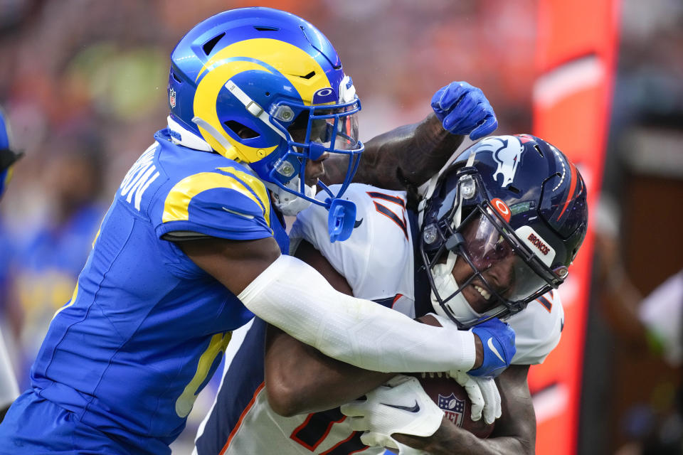 Denver Broncos wide receiver Lil'Jordan Humphrey is tackled by Los Angeles Rams cornerback Tre Tomlinson during the first half of an NFL preseason football game Saturday, Aug. 26, 2023, in Denver. (AP Photo/David Zalubowski)