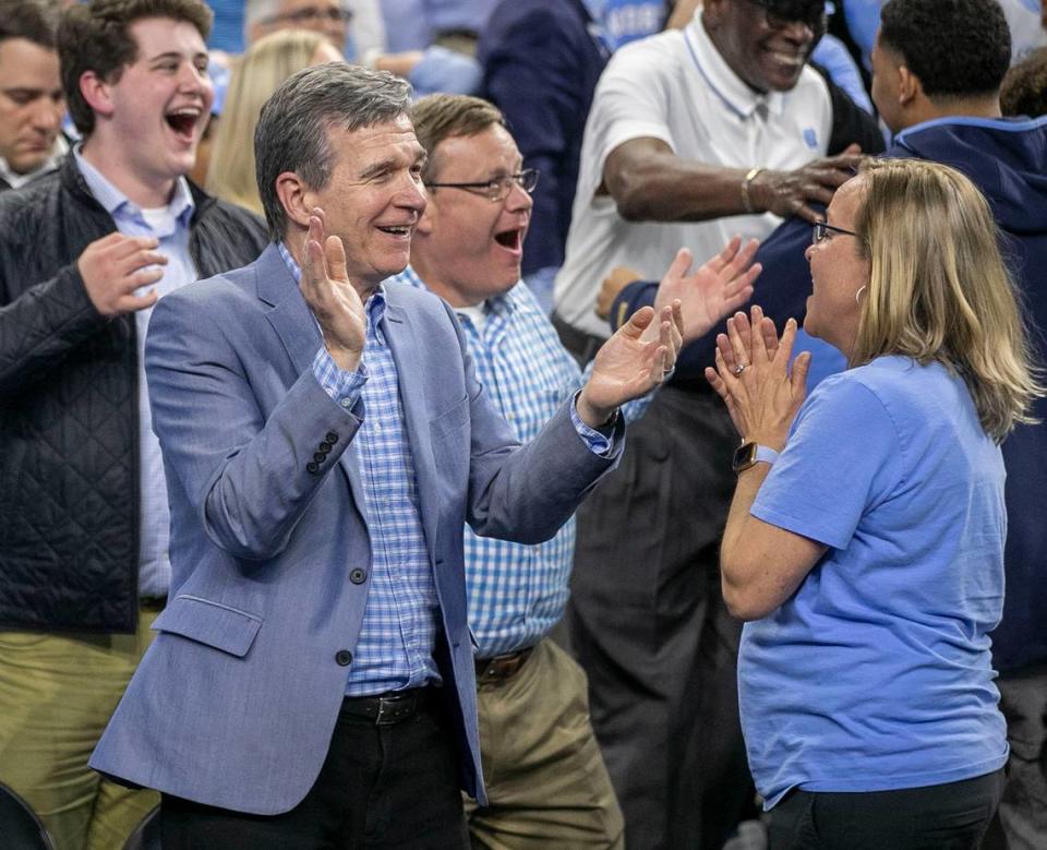 North Carolina Governor Roy Cooper and House Speaker Tim Moore relish in North Carolina’s 81-77 victory over Duke in the NCAA Final Four semi-final on Saturday, April 2, 2022 at Caesars Superdome in New Orleans, La.