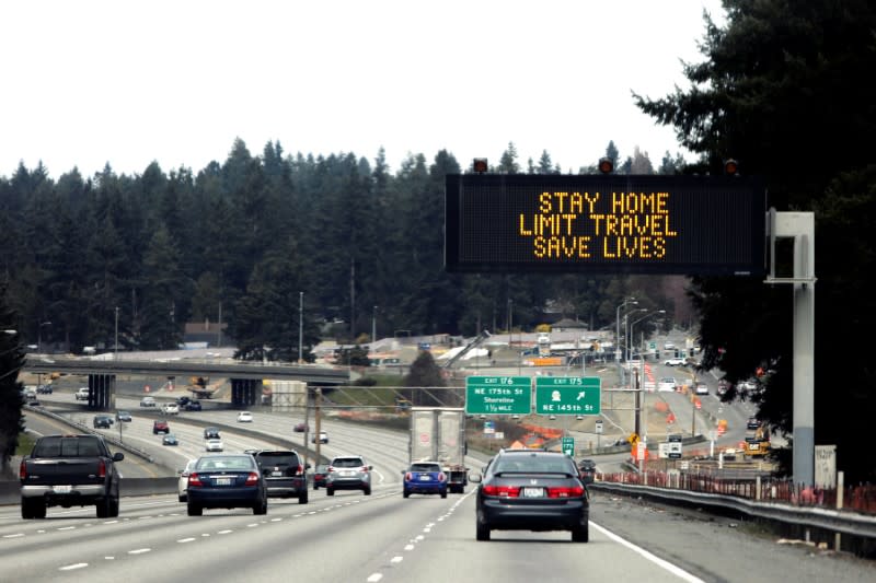A sign that reads "Stay home, limit travel, save lives" is pictured on northbound Interstate 5 as efforts continue to help slow the spread of coronavirus disease (COVID-19) in Seattle, Washington