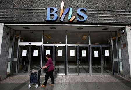 FILE PHOTO: A woman walks past the Wood Green branch of department store chain BHS, after its final closure, in London, Britain August 28, 2016. REUTERS/Peter Nicholls/File Photo