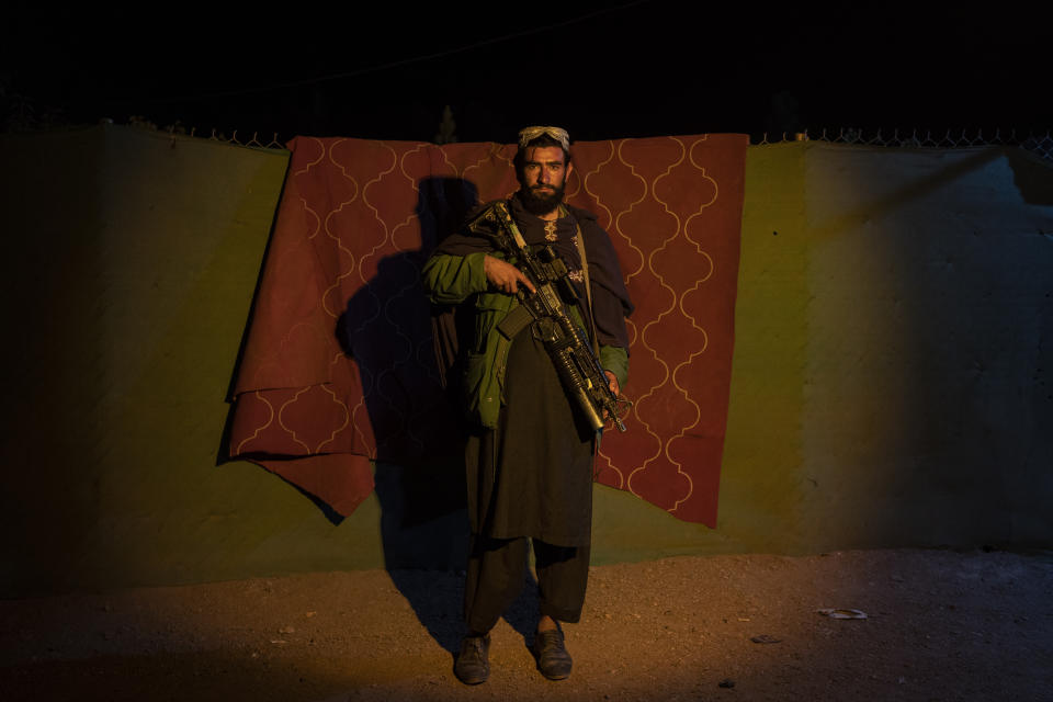 A Taliban fighter poses for a photo at a check point in Herat Afghanistan, on Monday, Nov. 29, 2021. Since the Taliban's takeover of Afghanistan just over three months ago amid a chaotic withdrawal of U.S. and NATO troops, its fighters have changed roles, turning from fighting in the mountains and the fields to running the country. (AP Photo/ Petros Giannakouris)