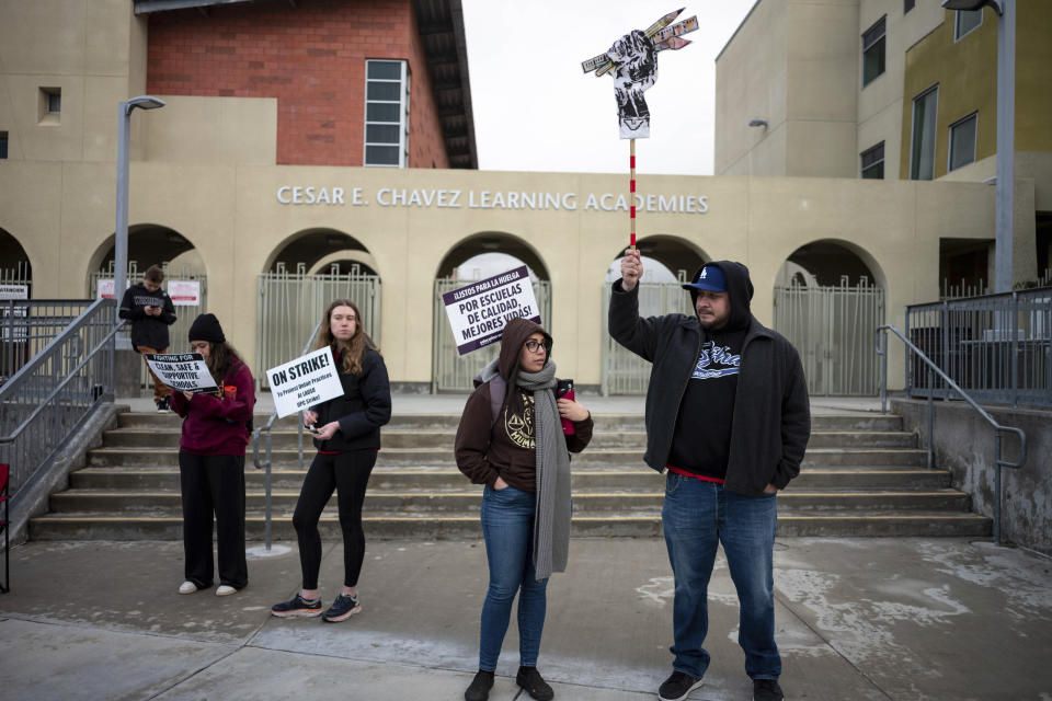 Teaches and supporters picket outside Cesar Chavez Learning Academy in San Fernando, Calif., Thursday, March 23, 2023, on the third day of a strike by SEIU and supported by UTLA for higher wages for Angeles Unified School District support staff. The 3-day strike left thousands of students out of class. (David Crane/The Orange County Register via AP)