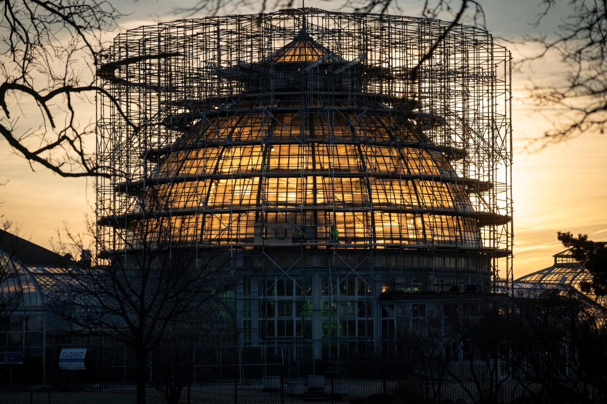 Sunrise shines through the main dome at the Anna Scripps Whitcomb Conservatory on Belle Isle in Detroit on Monday, Jan. 16, 2023. The dome will soon be shrouded in shrink wrap during a $10 million renovation to make needed structural repairs including new glass.
