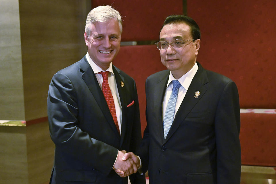 FILE - In this Nov. 4, 2019, file photo, U.S. National Security advisor Robert O'Brien, left, shakes hands with China's Premier Li Keqiang during a bilateral meeting in Bangkok on the sidelines of the 35th Association of Southeast Asian Nations (ASEAN) Summit. The United States and China again traded barbs over freedom of navigation in the South China Sea at the annual summit of leaders of the Association of Southeast Asian Nations in Thailand. (Romeo Gacad/Pool Photo via AP, File)