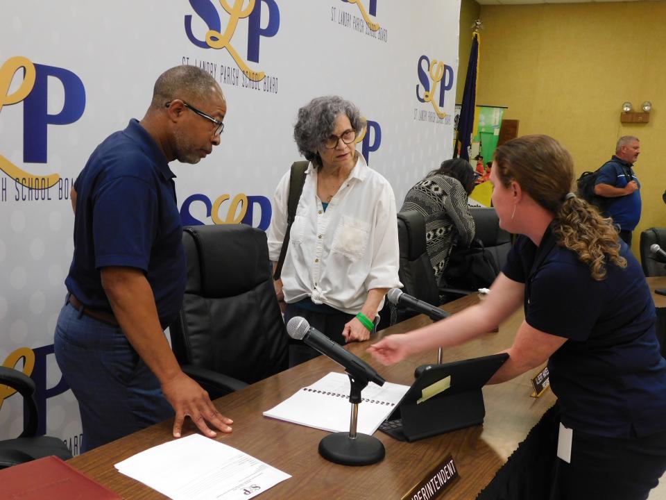 St. Landry School Superintendent Patrick Jenkins discusses school spending plans with board member Mary Ellen Donatto and former Finance Director Tressa Miller.