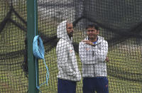 India's Shikhar Dhawan, left, listens to a member of team support staff in the nets during a training session ahead of their Cricket World Cup match against Afghanistan at the Hampshire Bowl in Southampton, England, Wednesday, June 19, 2019. (AP Photo/Aijaz Rahi)