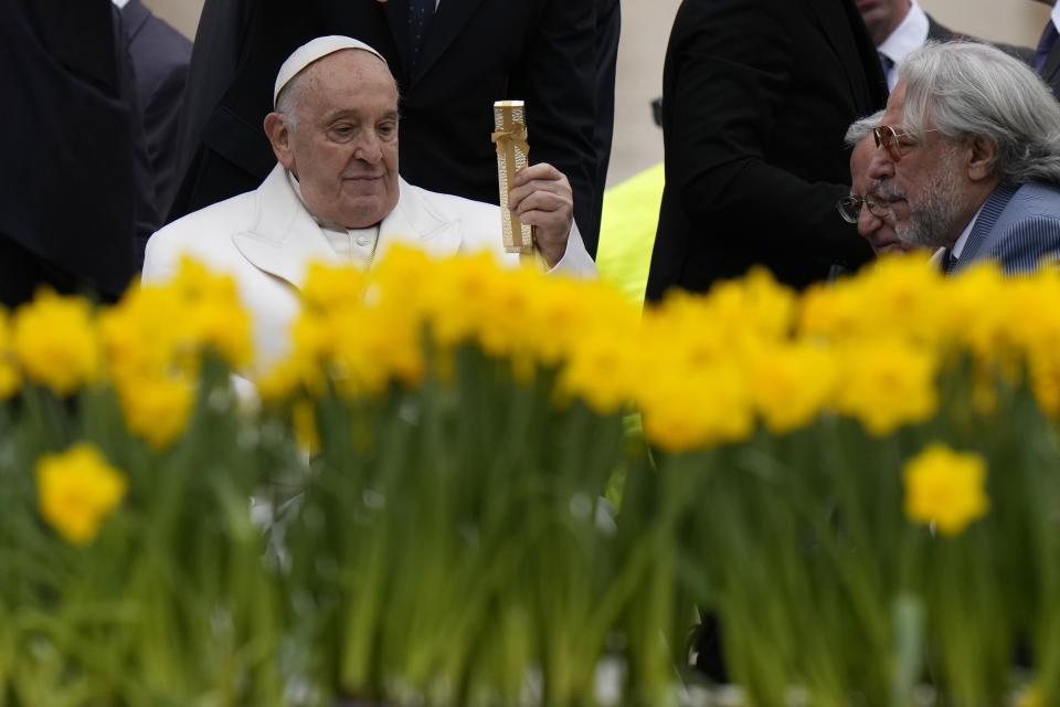 Pope Francis receives a gift at the end of his weekly general audience in St. Peter's Square, at the Vatican, Wednesday, April 3, 2024. (AP Photo/Alessandra Tarantino)