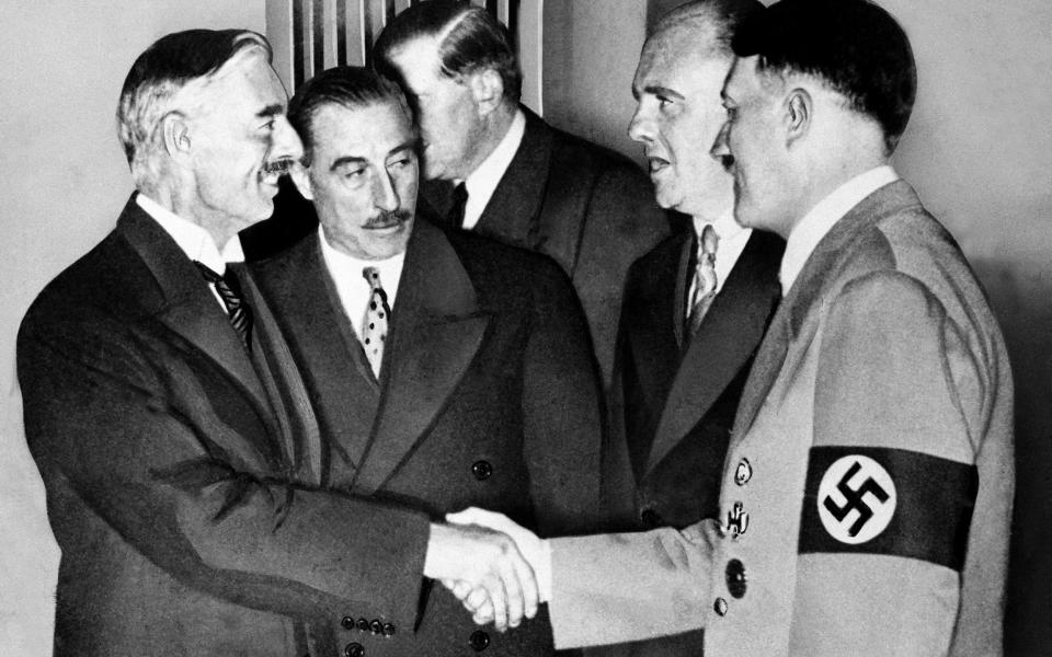 Adolf Hitler greets Neville Chamberlain at Munich in 1938 - Universal Images Group Editorial