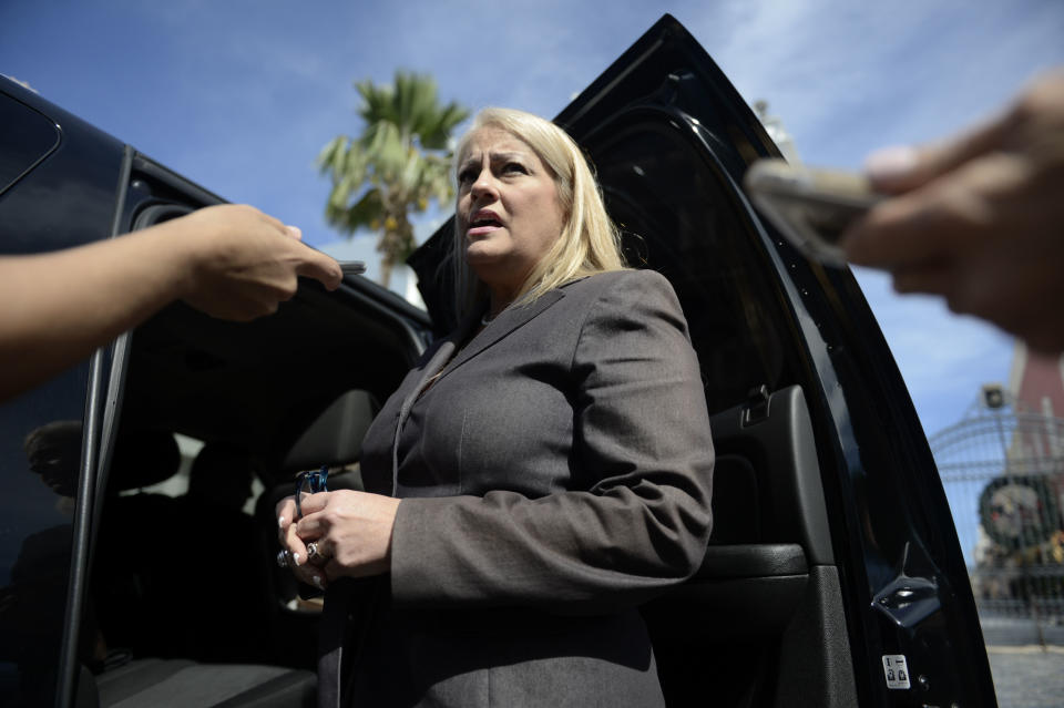 FILE - In this Jan. 16, 2018 file photo, then Puerto Rico Justice Secretary Wanda Vazquez answers reporters' questions, in San Juan, Puerto Rico. Vazquez is to become Puerto Rico's new Governor after Gov. Ricardo Rossello said, Wednesday, July 24, 2019, that he is resigning Aug. 2 after weeks of protests over leaked obscene, misogynistic online chats. (AP Photo/Carlos Giusti, File)