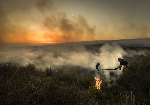 Firefighters tackle a wildfire on Winter Hill near Bolton. (Photo by Danny Lawson/PA Images via Getty Images)