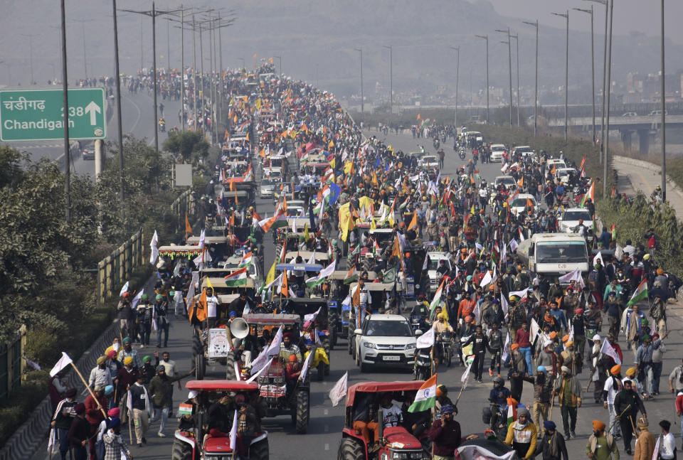Farmers participate in a protest march towards the capital during India's Republic Day celebrations in New Delhi, India, Tuesday, Jan. 26, 2021. Tens of thousands of farmers drove a convoy of tractors into the Indian capital as the nation celebrated Republic Day on Tuesday in the backdrop of agricultural protests that have grown into a rebellion and rattled the government. (AP Photo/Dinesh Joshi)
