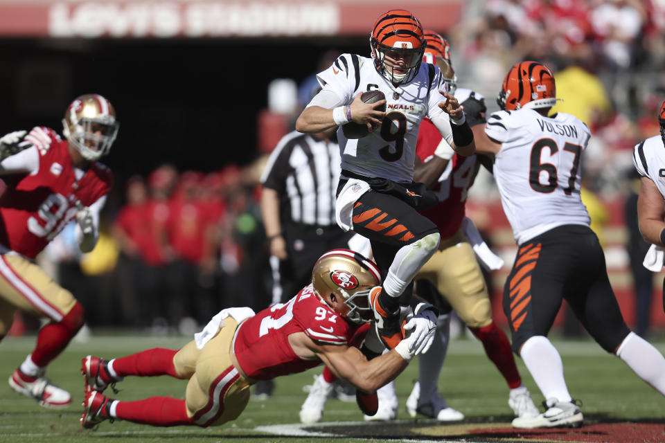 Cincinnati Bengals quarterback Joe Burrow (9) runs against San Francisco 49ers defensive end Nick Bosa (97) during the first half of an NFL football game in Santa Clara, Calif., Sunday, Oct. 29, 2023. (AP Photo/Jed Jacobsohn)