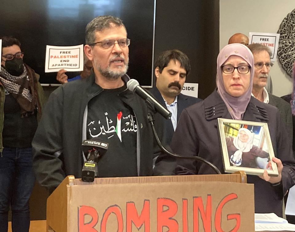 Mohammad Hamad of Brookfield speaks about his sister who was killed in an Israeli airstrike on a market Monday. His wife, Heather Gilvary-Hamad, holds an image of Faheemah Jameel Hamad, 66.
