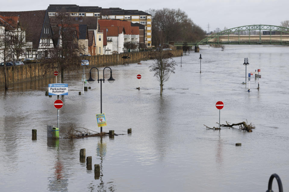 The "Schlagde" parking lot is flooded in Minden, Germany, Saturday Dec. 30, 2023. Despite a slight easing of the water levels, numerous streams and rivers in North Rhine-Westphalia continue to flood. (Friso Gentsch/dpa via AP)