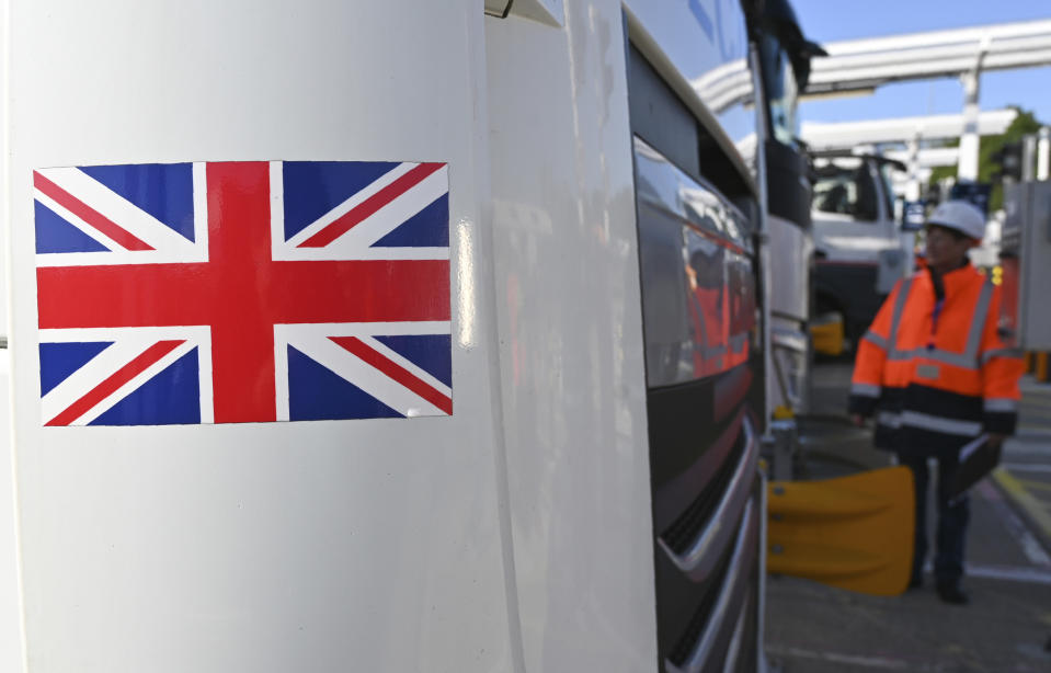 An employee of Eurotunnel checks a British truck on its way to France during a day of test in case of no deal Brexit at the entrance of the Channel tunnel in Folkestone, Tuesday, Sept. 17, 2019. British Prime Minister Boris Johnson has said after a meeting with European Commission President Jean-Claude Juncker that "there is a good chance" of a Brexit deal with the European Union. (Denis Charlet, Pool via AP)