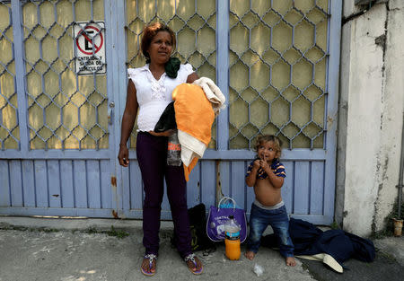 A boy looks at his mother after they arrived with fellow Central American migrants in a caravan as the move through Mexico toward the U.S. border, in Puebla, Mexico April 6, 2018. REUTERS/Henry Romero