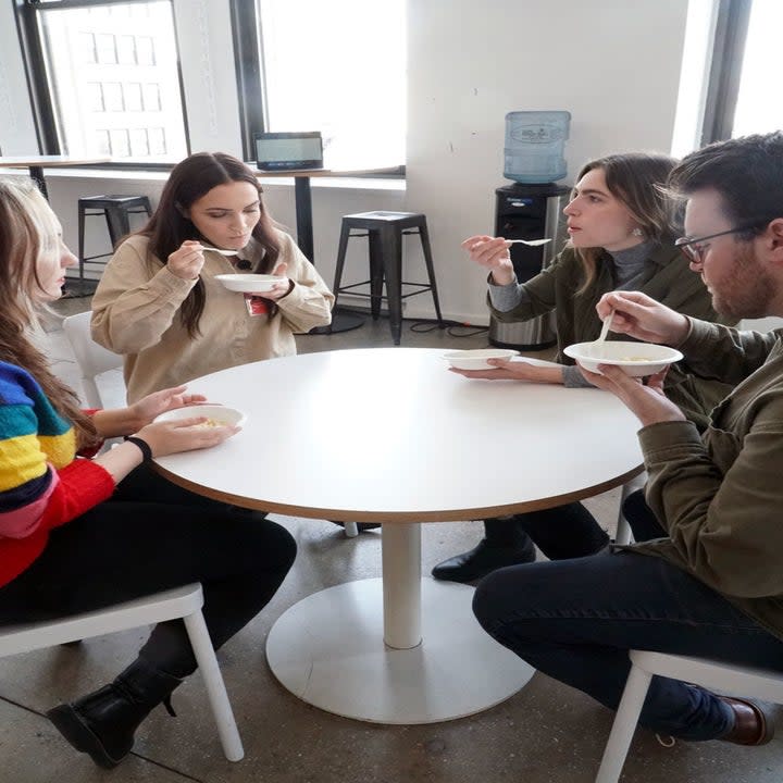 People gathered around a table eating