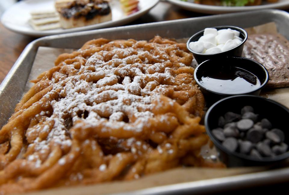 Buddy’s Spaghetti Dessert, funnel cake fries for the “spaghetti”, M&M's, mini marshmallows, chocolate chips, chocolate syrup, chocolate pop tarts, at Crooked Hammock Brewery in Lewes, Delaware. Top it yourself just like Buddy the Elf. 100 percent of profits go to Make-A-Wish Foundation.