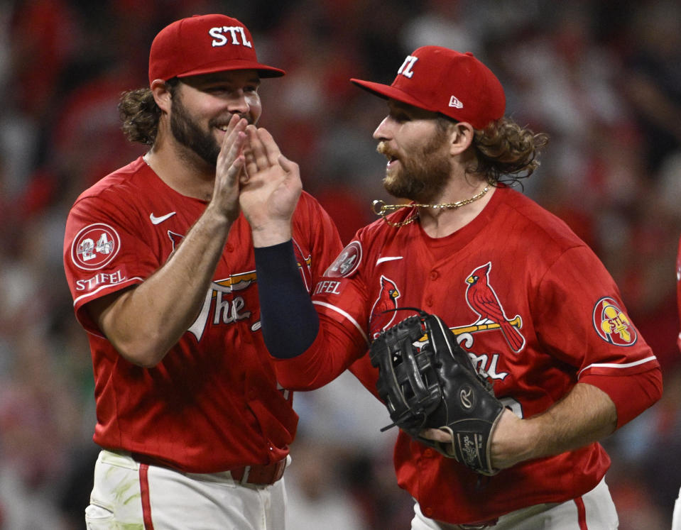 St. Louis Cardinals right fielder Alec Burleson, right, celebrates with left fielder Brendan Donovan, right, after defeating the Cincinnati Reds in a baseball game, Friday, June 28, 2024, in St. Louis. (AP Photo/Joe Puetz)