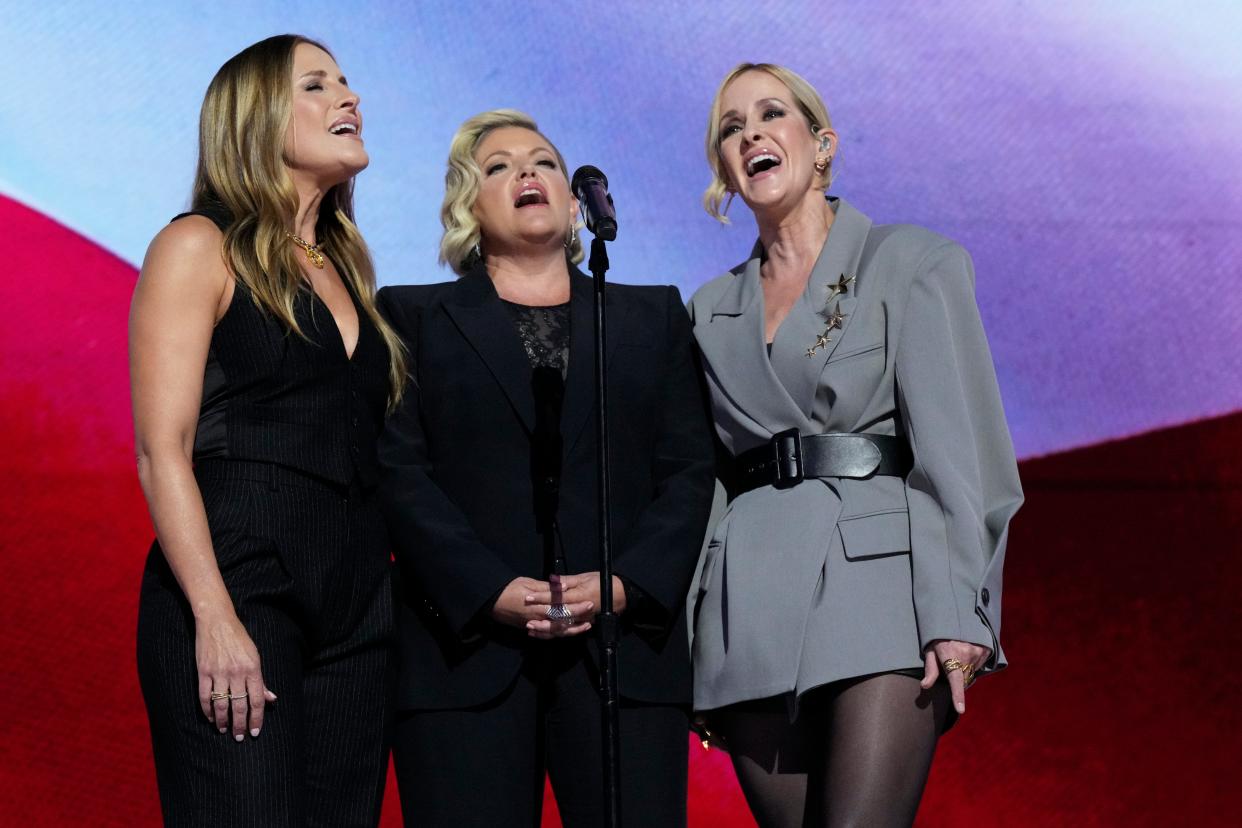 Members of The Chicks (L-R) Emily Strayer, Natalie Maines and Martie Maguire sing the National Anthem during the final day of the Democratic National Convention at the United Center.